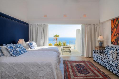 a bedroom with two beds and a view of the ocean at Villa Esencia Del Mar in Cabo San Lucas