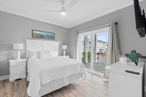a white bedroom with a bed and a large window at The Grand View 5bedrooms 5 Ba, Elevator, Heated Pool in Ocean Isle Beach