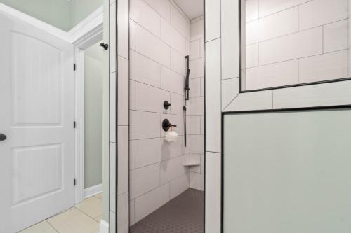 a bathroom with a shower with a glass door at The Grand View 5bedrooms 5 Ba, Elevator, Heated Pool in Ocean Isle Beach