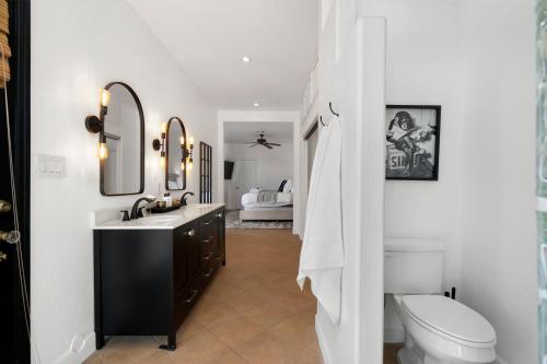 a bathroom with a toilet and a sink and mirror at Walk To Dt Phx Convention Center Historic in Phoenix