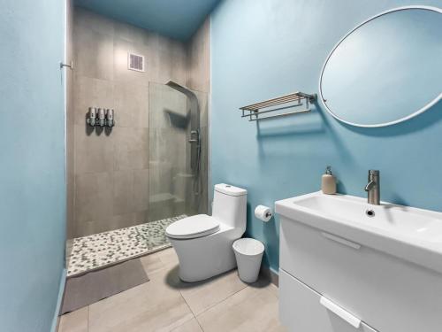 a bathroom with a shower and a toilet and a sink at Aquabella 6 Tropical Escape in Isla Verde in San Juan