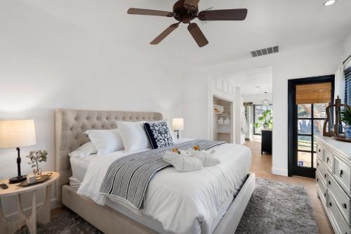 a bedroom with a large bed with a ceiling fan at Walk To Dt Phx Convention Center Historic in Phoenix