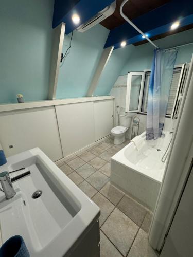a bathroom with a sink and a tub and a toilet at La casina di Ginevra in Marina di Massa