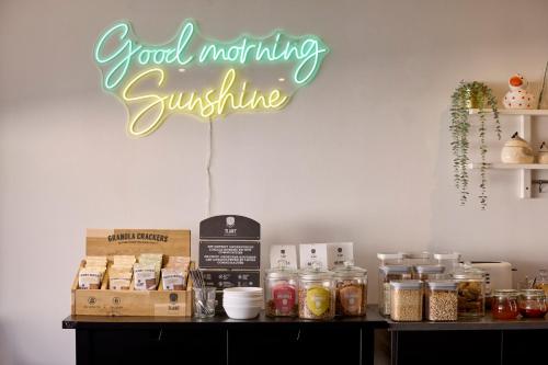 a sign that says good morning sunshine on a wall at Alpha Hotel and Aparthotel in Tienen