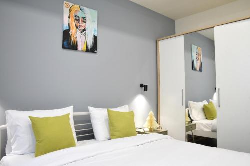 a bedroom with a white bed and a mirror at Newly Renovated Condo Steps to Republic Square in Yerevan