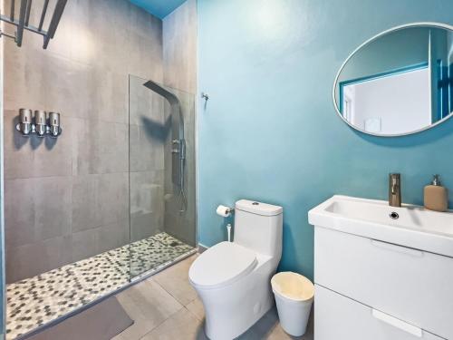 a bathroom with a shower and a toilet and a sink at Aquabella 7 Paradise Stay in Isla Verde in San Juan