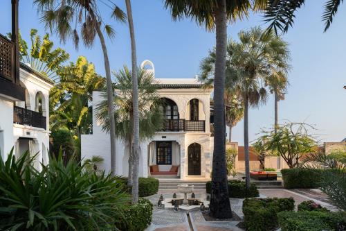 a house with palm trees in front of it at Villa Maroc Resort in Pran Buri