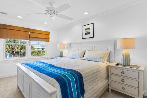 a white bedroom with a bed and a window at Ocean Front 3 Bedroom 2 Bath Home, Pet Friendly in Ocean Isle Beach