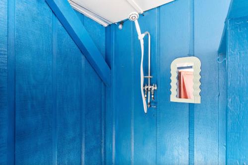 a blue wall with a door with a fire hydrant at Remodeled Beach Happy 4 Bedroom 2 Bathroom for 9 Guests! in Ocean Isle Beach
