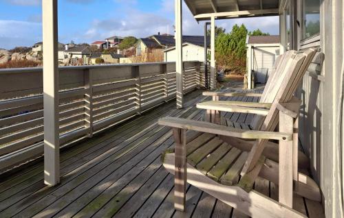 a pair of chairs sitting on the porch of a house at 4 Bedroom Cozy Home In Sirevåg in Sirevåg