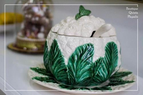 a green and white cake on a plate on a table at Boutique Quinta Physalis in Fenais da Luz