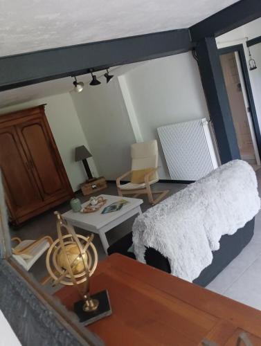 a living room with a bed and a table at Gite Roc&Gravillon 2 Etoiles in Vitrac