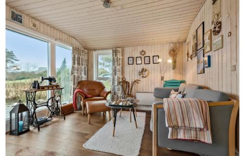 a living room with a couch and chairs at 2 Bedroom Amazing Home In Farsø in Farsø