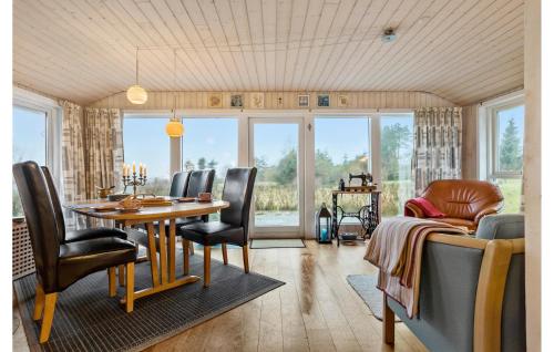 a dining room with a table and chairs at 2 Bedroom Amazing Home In Farsø in Farsø