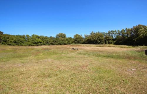 a group of picnic tables in a field at 3 Bedroom Amazing Home In Samsø in Sælvig