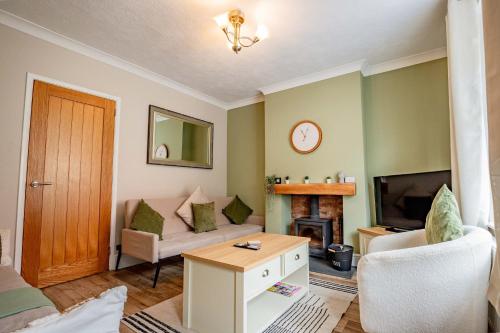 a living room with a couch and a fireplace at Host & Stay - Mayfield House in Ashbourne