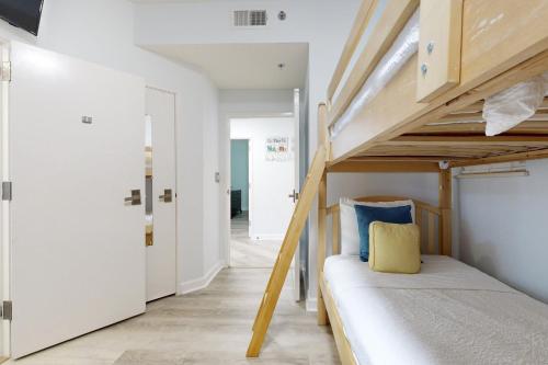 a bedroom with a bunk bed and a hallway at TOPS'L Tides 0207 in Destin