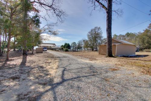 a gravel road leading to a shed and trees at Waterfront Gem with Fire Pits and Dock in Georgetown in Georgetown
