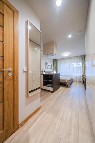 a living room with a large mirror on the wall at Gynėjų Self Check-in Apartments - Lollo Stay in Vilnius