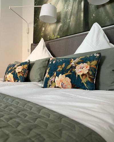 a bed with two pillows on top of it at Ferienwohnung Schönwälder mit kleiner Terrasse und WALL BOX in Buxtehude