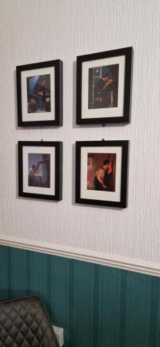 a group of pictures on a wall in a room at The Dudley Hotel in Blackpool