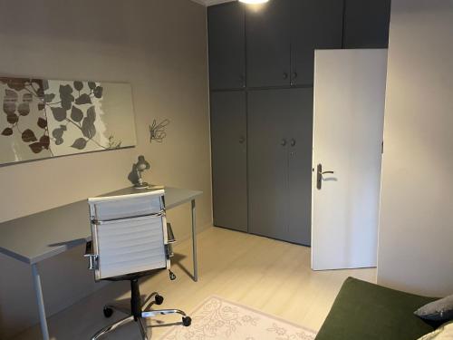 a bedroom with a desk and a bed and a door at Luxury-Elegant apartment in the heart of Patras​ in Patra