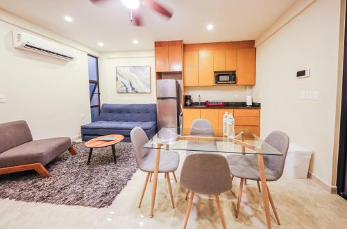 a living room with a glass table and chairs at Gaia, Retreat Close to the Sea in Puerto Morelos in Puerto Morelos