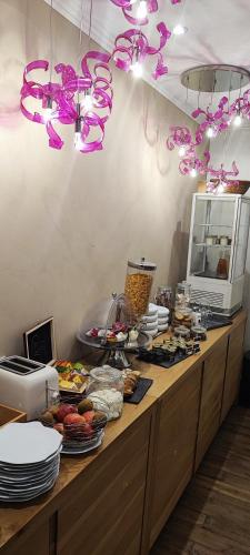 a buffet line with food and purple bows at RELAIS DU TAURION in Saint-Priest-Taurion