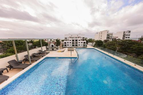 a swimming pool on the roof of a building at Gaia, Retreat Close to the Sea in Puerto Morelos in Puerto Morelos