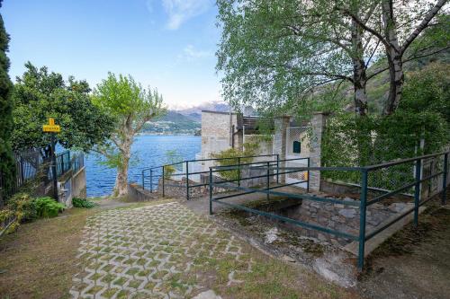 a building with a staircase next to a body of water at Locanda Dell'Era in Dorio
