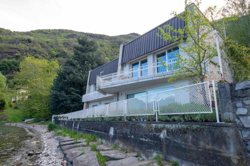 a house on a retaining wall next to a river at Locanda Dell'Era in Dorio