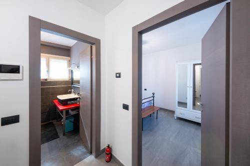 a hallway with a mirror and a room with a desk at Locanda Dell'Era in Dorio