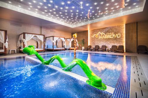 a pool with a water slide in a hotel room at Park & Spa Hotel Markovo in Plovdiv