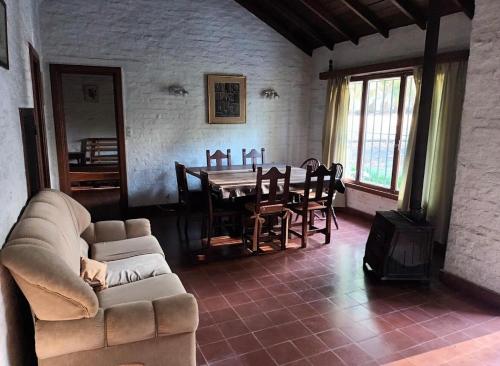 a living room with a couch and a dining room table at San Pedro de la Vigilancia in Balcarce