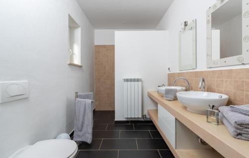 a white bathroom with a sink and a toilet at Villa Mali Raj in Žikovići