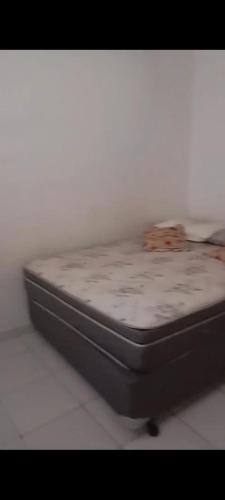 a close up of a bed sitting in a room at Casa de praia Mongaguá in Mongaguá