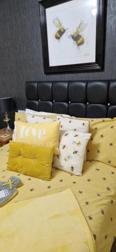 a bedroom with a bed with yellow sheets and pillows at The Dudley Hotel in Blackpool