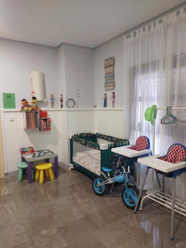 a room with a bed and two tables and two chairs at Casa del olivo Lucio en Alomartes in Alomartes