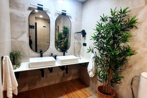 a bathroom with two sinks and a mirror at office 2036 in Tres Cantos