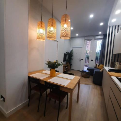 a living room with a table and two lights at office 2036 in Tres Cantos