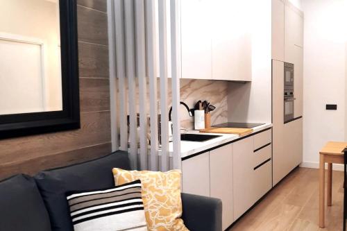 a kitchen with a black chair in a room at office 2036 in Tres Cantos