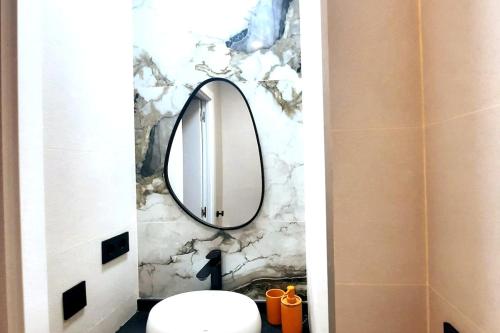 a bathroom with a mirror and a sink at office 2036 in Tres Cantos