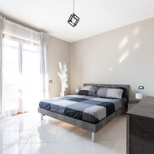 a bedroom with a large bed in a white room at Casa Libeccio in Quartu SantʼElena