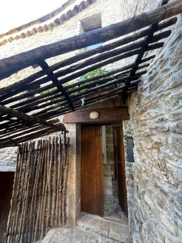 an entrance to a stone building with a wooden ceiling at Dimora Forgione B&B - Pietrelcina in Pietrelcina