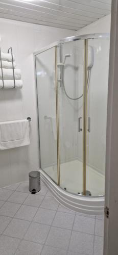 a shower in a bathroom with a glass door at The Dudley Hotel in Blackpool