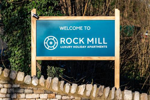 a sign that says rock mill over a brick fence at Rock Mill 1 Bed Apartment 32 in Stoney Middleton