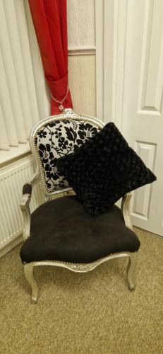 a chair with a pillow on top of it at The Dudley Hotel in Blackpool