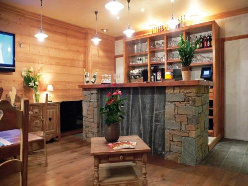 un bar dans un restaurant avec une cheminée en pierre dans l'établissement Apartment in Brides-les-Bains for 8 People, à Brides-les-Bains