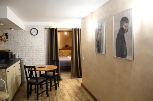 a kitchen with a table and a room with a bedroom at Old Town Apartment with a separate entrance in Kaunas