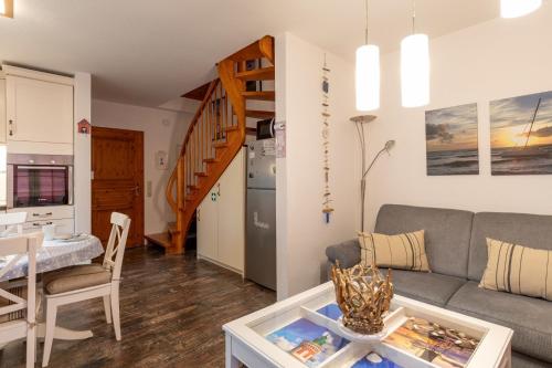 a living room with a couch and a table at Sperlingsnest in Neßmersiel